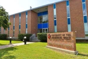 Front view of the University of the Incarnate Word School of Osteopathic Medicine building with a sign in front of the building.
