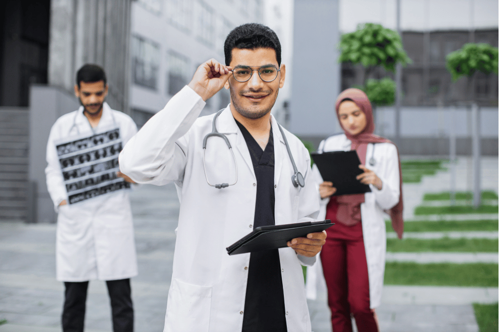 three doctors outside of a medical center