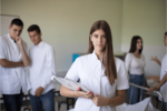 female medical student preparing to take the COMLEX exam, four students in the background