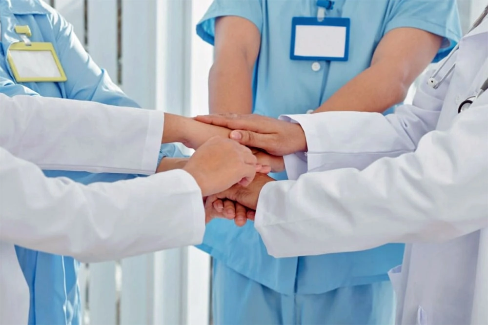 Medical worker stacking hands