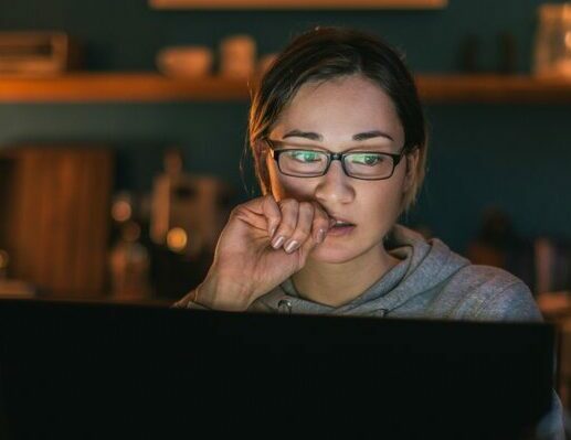 Woman with glasses studying with laptop