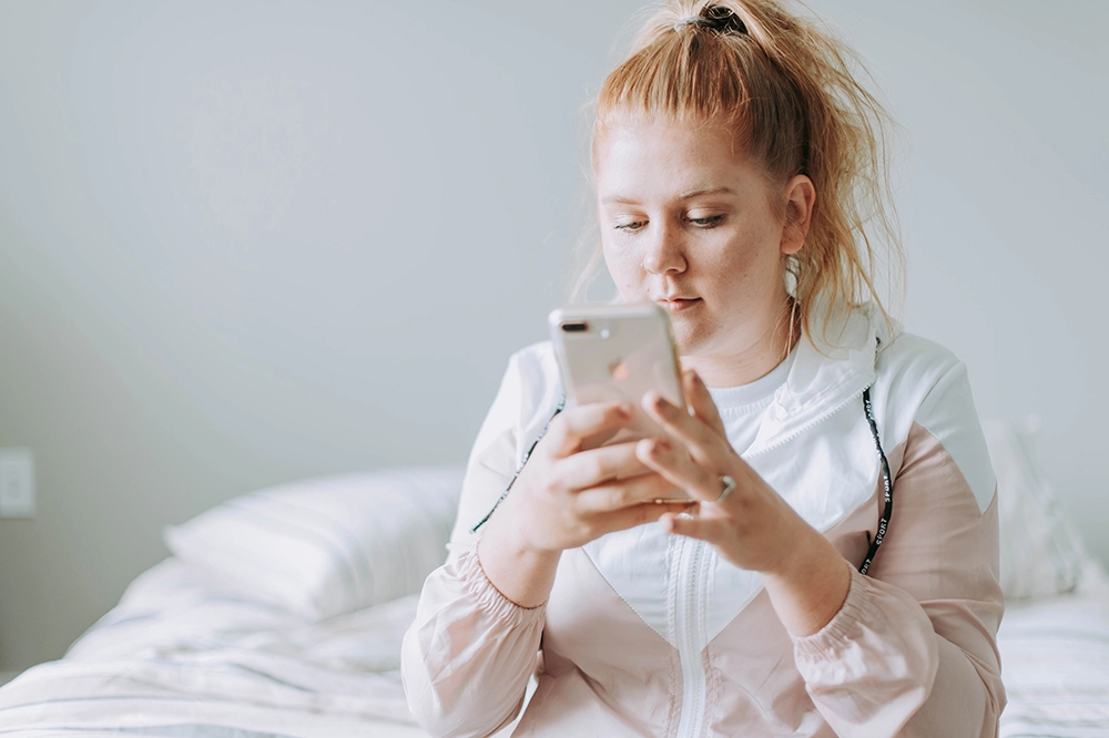 A premed student scrolling social media to learn how to boost med school chances