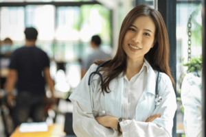 female doctor smiling at the camera with arms crossed