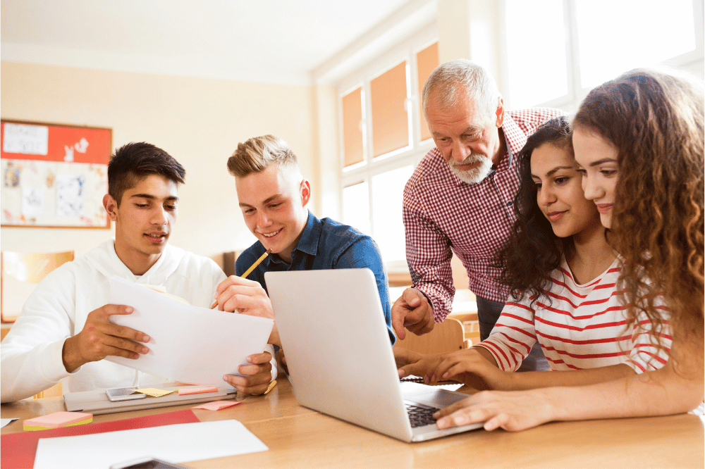 four pre-med students and a professor studying for the MCAT