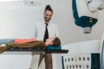 A young doctor helping a patient get ready fora procedure
