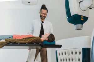 A young doctor helping a patient get ready fora procedure