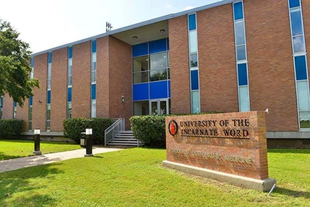 Front view of the University of the Incarnate Word School of Osteopathic Medicine building with a sign in front of the building.