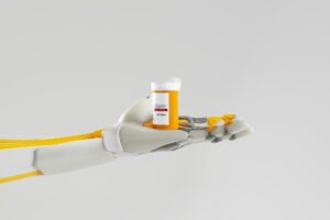 A robot hand holding a medicine bottle