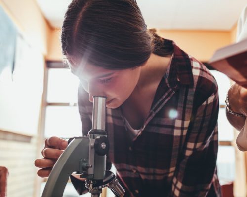 Student looking through microscope